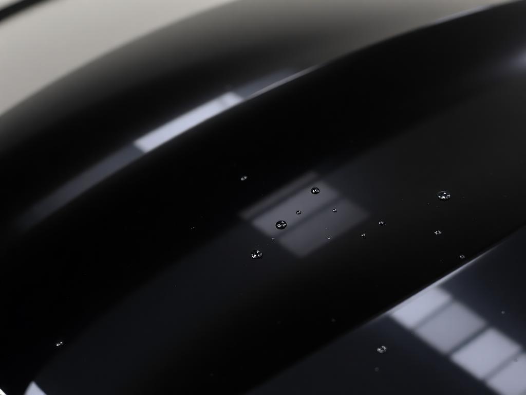 glossy dark car paint with mirror reflections after detailing